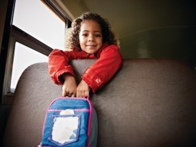Girl on bus with lunchpail